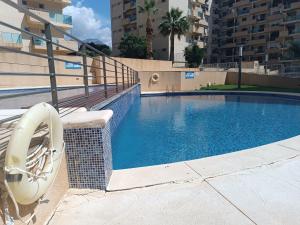 a swimming pool with a slide in a building at Fantástico apartamento playa in Cala de Finestrat
