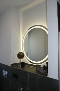 a bathroom with a round mirror on a counter at Dock2Apartment Rügen Whg 3 großer Balkon, ruhige Lage in Lohme