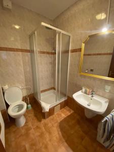 a bathroom with a shower and a toilet and a sink at Penzión TATRA INN in Čadca