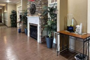 a lobby with a stone fireplace in a building at Comfort Inn & Suites Rogersville in Rogersville