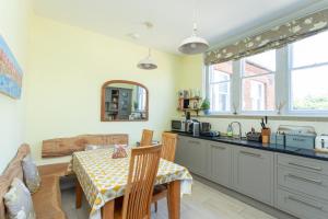 a kitchen with a table and a dining room at The Old Schoolhouse in Whitstable