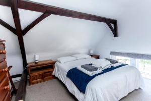 a bedroom with a bed and a large window at The Old Schoolhouse in Whitstable