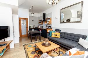 a living room with a couch and a table at The Old Schoolhouse in Whitstable