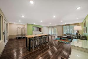 インバネスにあるWoodSpring Suites Invernessのテーブルと椅子のあるキッチンとリビングルーム