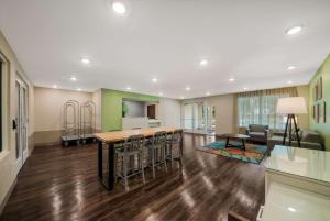 a kitchen and living room with a table and chairs at WoodSpring Suites Inverness in Inverness