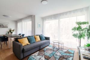 a living room with a couch and a table at Linda Terrace by Quokka 360 - modern one-bedroom flat with sun terrace in Locarno