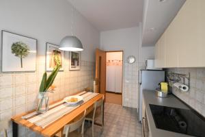 cocina con mesa de madera en una habitación en Appartamento Doria [5 minuti a piedi dal mare], en Andora