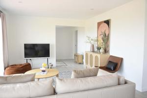 a living room with a couch and a table at Premium Comfortable Lake View 2BR in Taupo