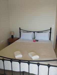 a bed with two white towels on top of it at AGNANTIO HOME in Monemvasia