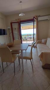 a living room with a table and a couch at AGNANTIO HOME in Monemvasia