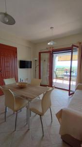 a dining room with a table and chairs in a room at AGNANTIO HOME in Monemvasia