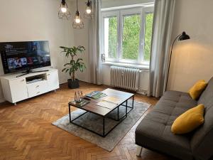 a living room with a couch and a coffee table at Apartment YuPa in Košice