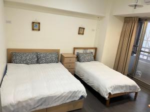 Postel nebo postele na pokoji v ubytování 果芒驛站旅店