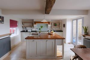 a kitchen with a wooden counter top in a room at The Old Sweet Shop, 4 Bedroom House 