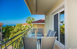 a balcony with a table and chairs and a view of the ocean at Aristotelis Apartment Lakithra-Lydia in Lakithra