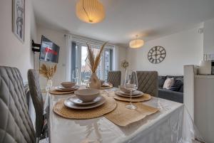 a dining room table with plates and bowls on it at Spacious 4 BR House w/Parking in Birmingham