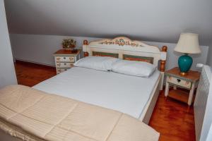 a bedroom with a white bed and two night stands at Cabana Kia 