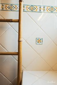 a bamboo ladder in a room with a tile ceiling at Hôtel Palombaggia in Porto-Vecchio