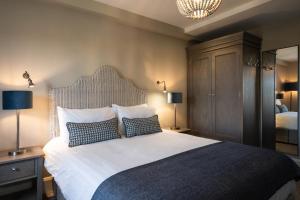 a bedroom with a large bed with two pillows at The Salthouse Hotel in Ballycastle