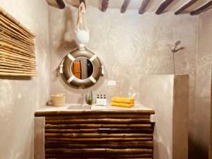 a bathroom with a sink and a mirror at Mama Root in Kizimkazi