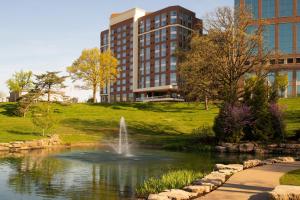 a fountain in a pond in front of a building at Residence Inn by Marriott St Louis Clayton in Clayton