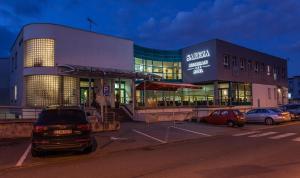 a building with cars parked in a parking lot at Sareza hotel in Ostrava