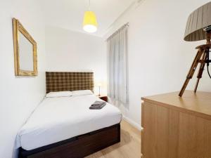 Postel nebo postele na pokoji v ubytování Casa Sagrada Familia