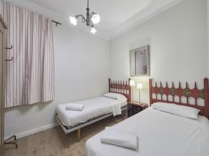 Postel nebo postele na pokoji v ubytování Casa Sagrada Familia
