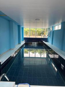 an empty swimming pool with blue walls and a large window at UREKI MARI MARI in Ureki
