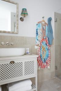 a bathroom with a sink and a mirror at El Escondite Tarifa in Tarifa