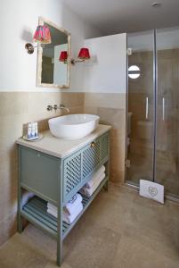 a bathroom with a sink and a shower at El Escondite Tarifa in Tarifa