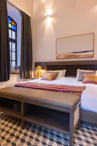 Postel nebo postele na pokoji v ubytování Kassa Boutique Hotel