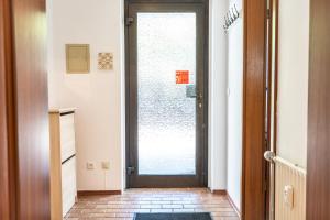 une porte donnant sur un couloir avec un sol en briques dans l'établissement Appartement Langhammer, à Tübingen