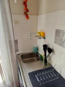 a small kitchen with a sink and a counter top at Comfy Studio in Lamía