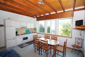 Una cocina y un comedor con mesa y sillas. en Gîte Les Jonquilles, en Le Bonhomme