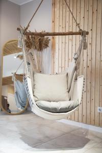 a hanging hammock chair in a room at Silence hotel in Cholpon-Ata