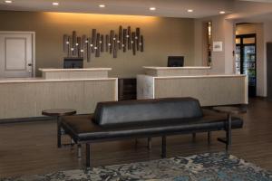 a waiting room with a bench in front of a counter at Residence Inn by Marriott Portland Vancouver in Vancouver