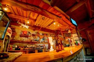 a bar with a lot of bottles of alcohol at Karczma nad Szumem in Józefów