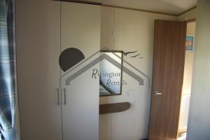 a door to a room with a sign on the wall at The Rivington Lodge in Heysham