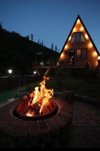 a fire pit in front of a house at night at greenparadisehouses in Fatsa