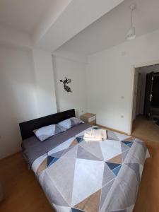 ein Schlafzimmer mit einem großen Bett mit geometrischem Muster in der Unterkunft Tatjana's Apartments Ohrid in Ohrid