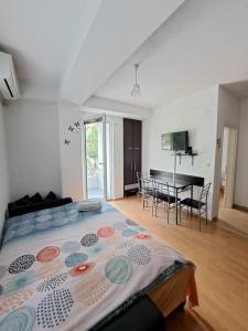 a bedroom with a bed and a dining room at Tatjana's Apartments Ohrid in Ohrid