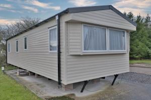 a tiny house is parked in a driveway at Solway Holiday Park in Silloth