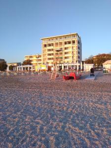 セニガッリアにあるHotel Atlanticの背景の建物がある海辺の遊び場