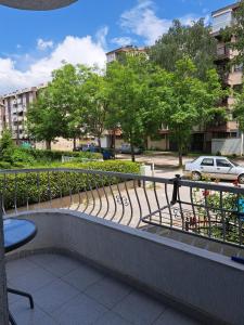 a bench in a park with trees and buildings at Tatjana's Apartments Ohrid in Ohrid