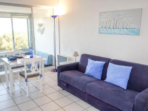 a living room with a couch and a table at Apartment Athéna Résidence by Interhome in Bandol