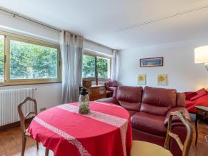 a living room with a red table and a couch at Apartment Le Richelieu by Interhome in Saint-Jean-de-Luz