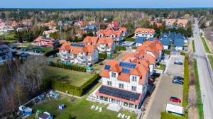 an aerial view of a large house with orange roofs at Dębki Playa Apartments in Dębki