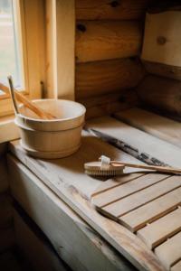 a wooden table with a bowl and utensils on it at Paunu Talu - Majutus ja Kajakid in Kekra