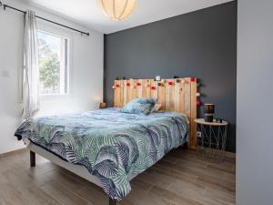 a bedroom with a bed with a wooden head board at Holiday Home Chalmeignes by Interhome in Saint-Germain-sur-Ay